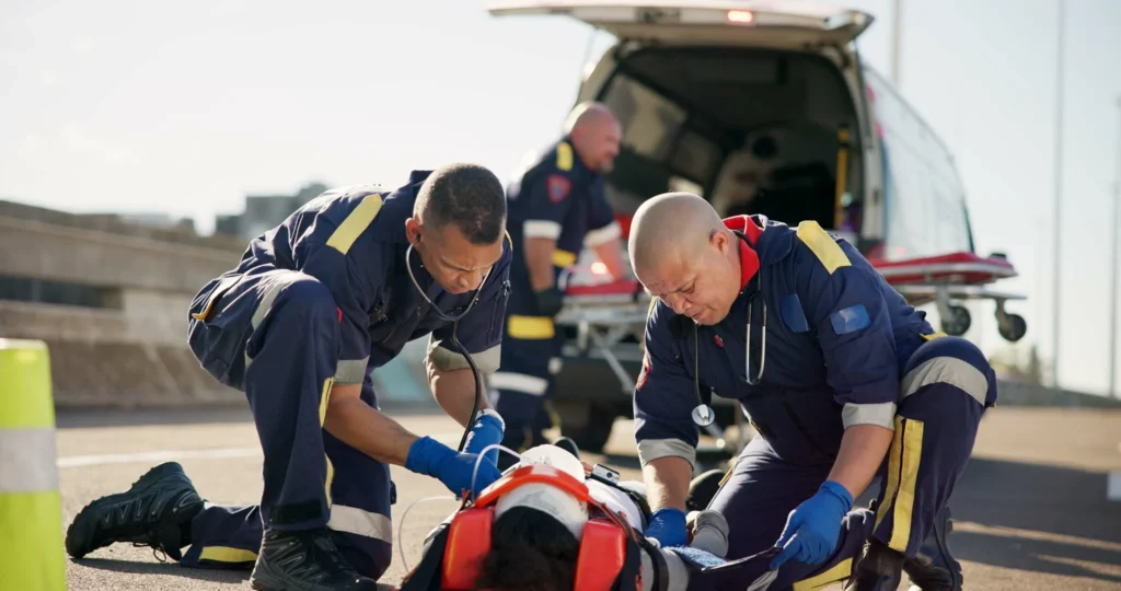 EMTs helping a pedestrian who was hit by a car.